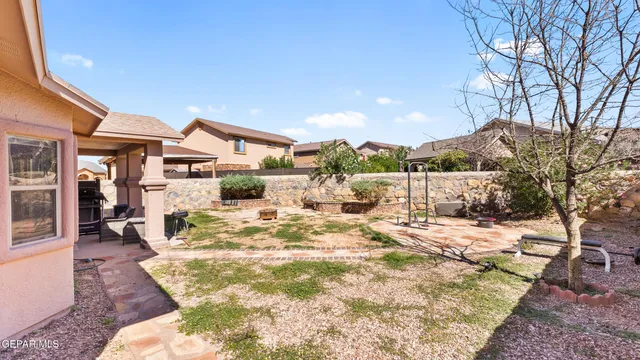 a view of a house with a yard covered in snow