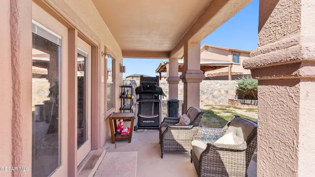 a living room with furniture and a floor to ceiling window