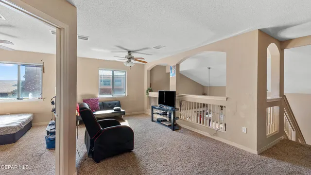 a living room with furniture and a baby crib