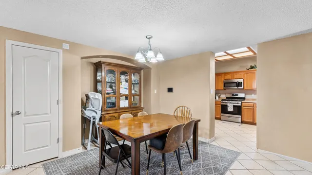a view of a dining room with furniture and chandelier