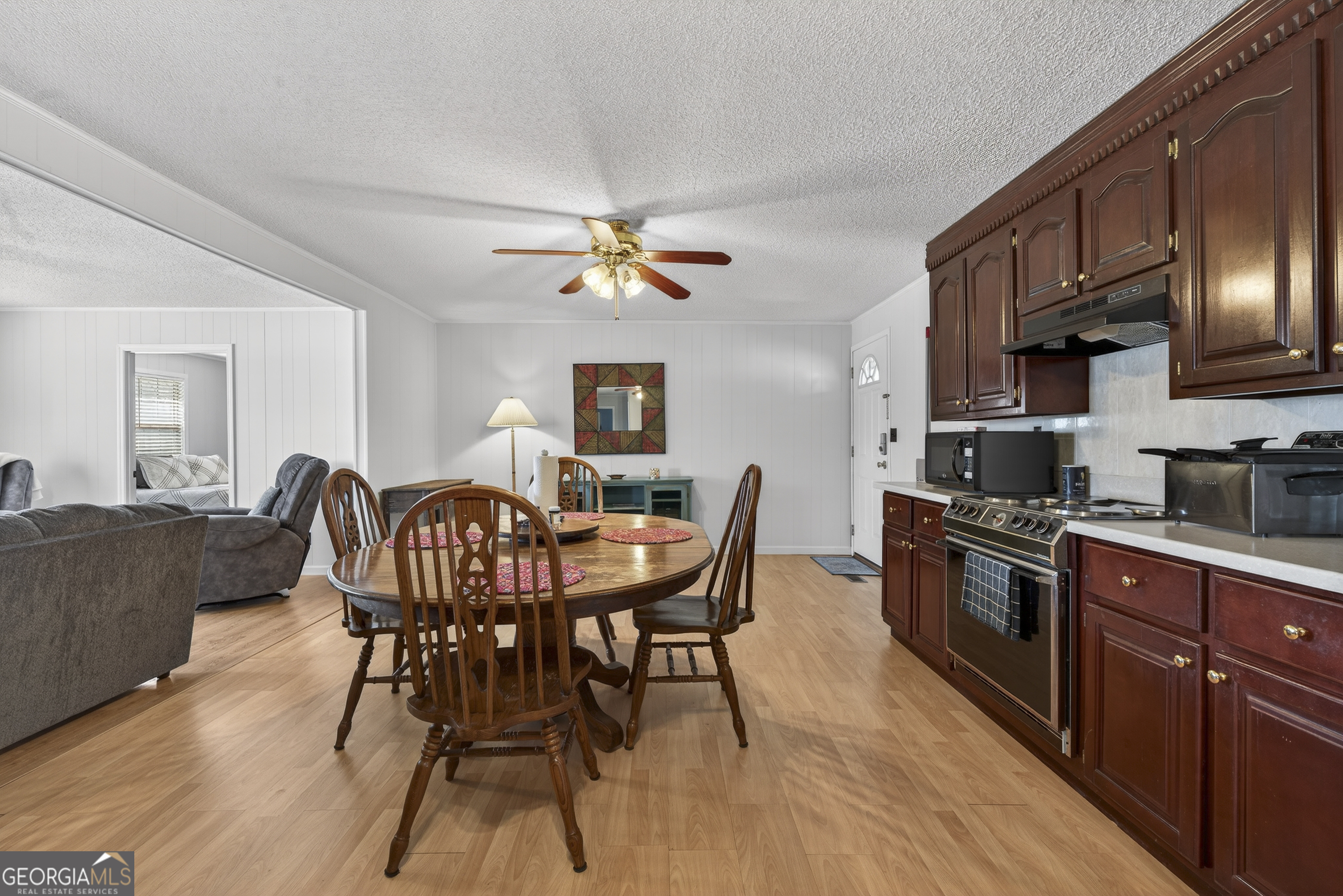 231 B Little Road Northwest Milledgeville, GA 31061 - Photo 14 of 67 a view of a dining room with furniture a chandelier and wooden floor