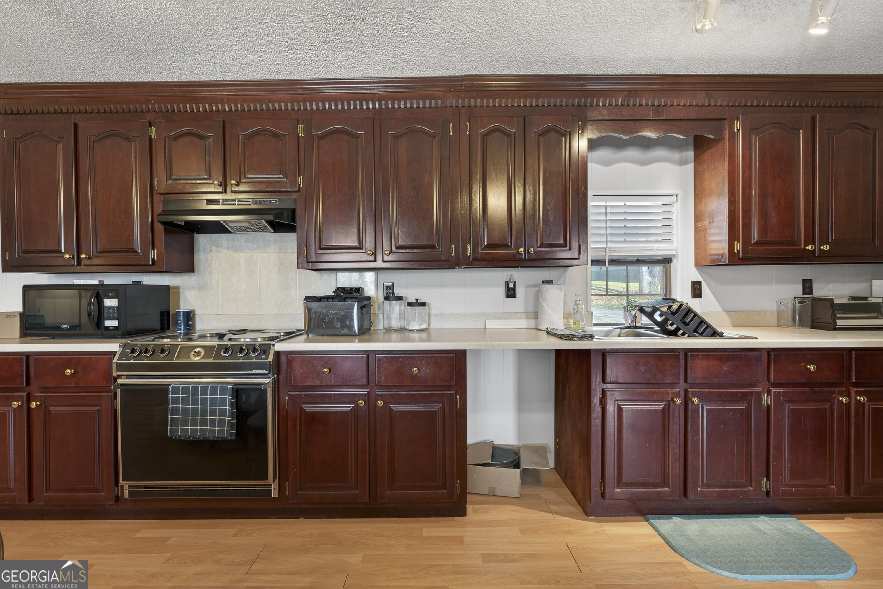 231 B Little Road Northwest Milledgeville, GA 31061 - Photo 15 of 67 a kitchen with stainless steel appliances granite countertop a stove and cabinets