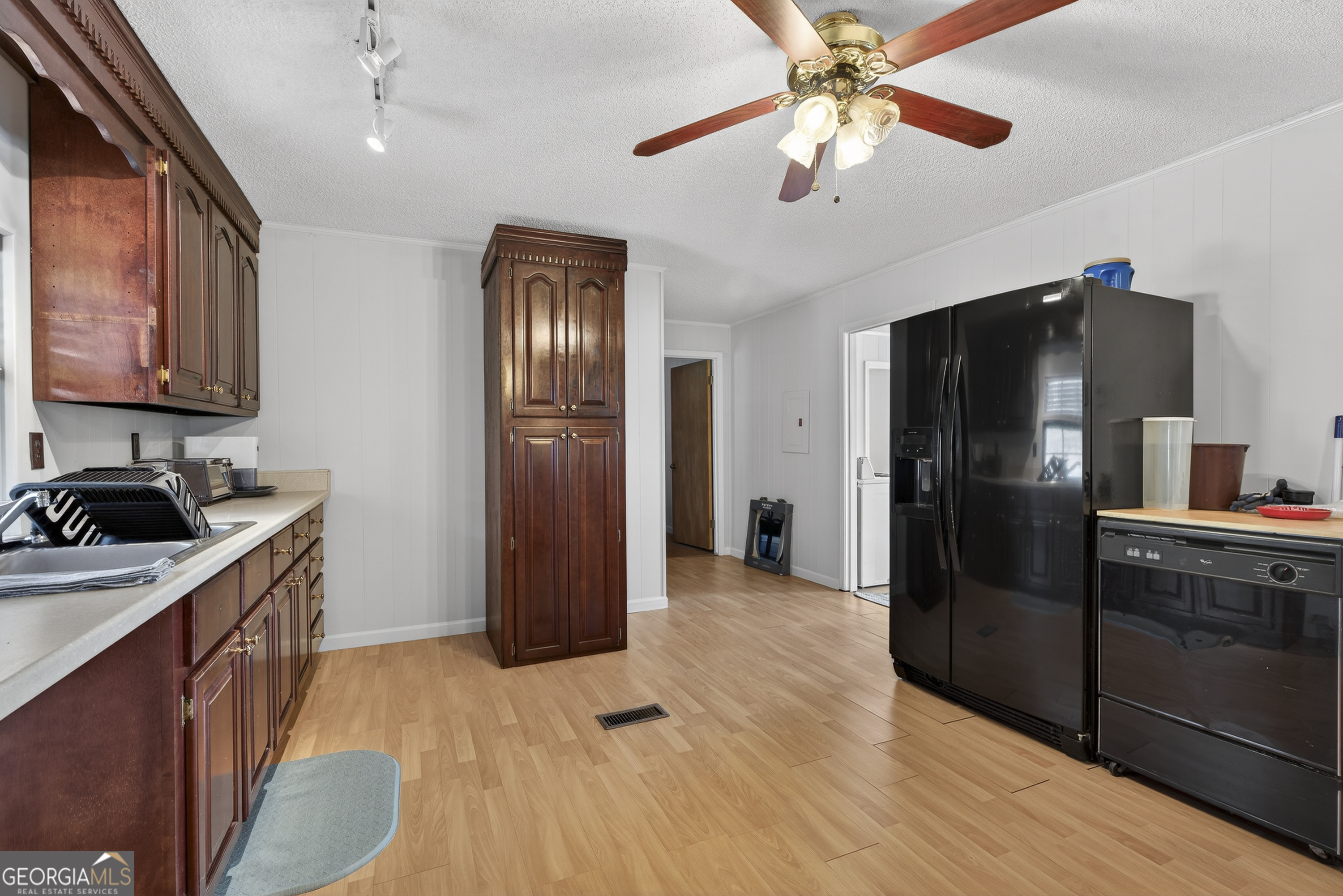 231 B Little Road Northwest Milledgeville, GA 31061 - Photo 17 of 67 a kitchen with stainless steel appliances granite countertop a refrigerator a stove and a sink with wooden floor