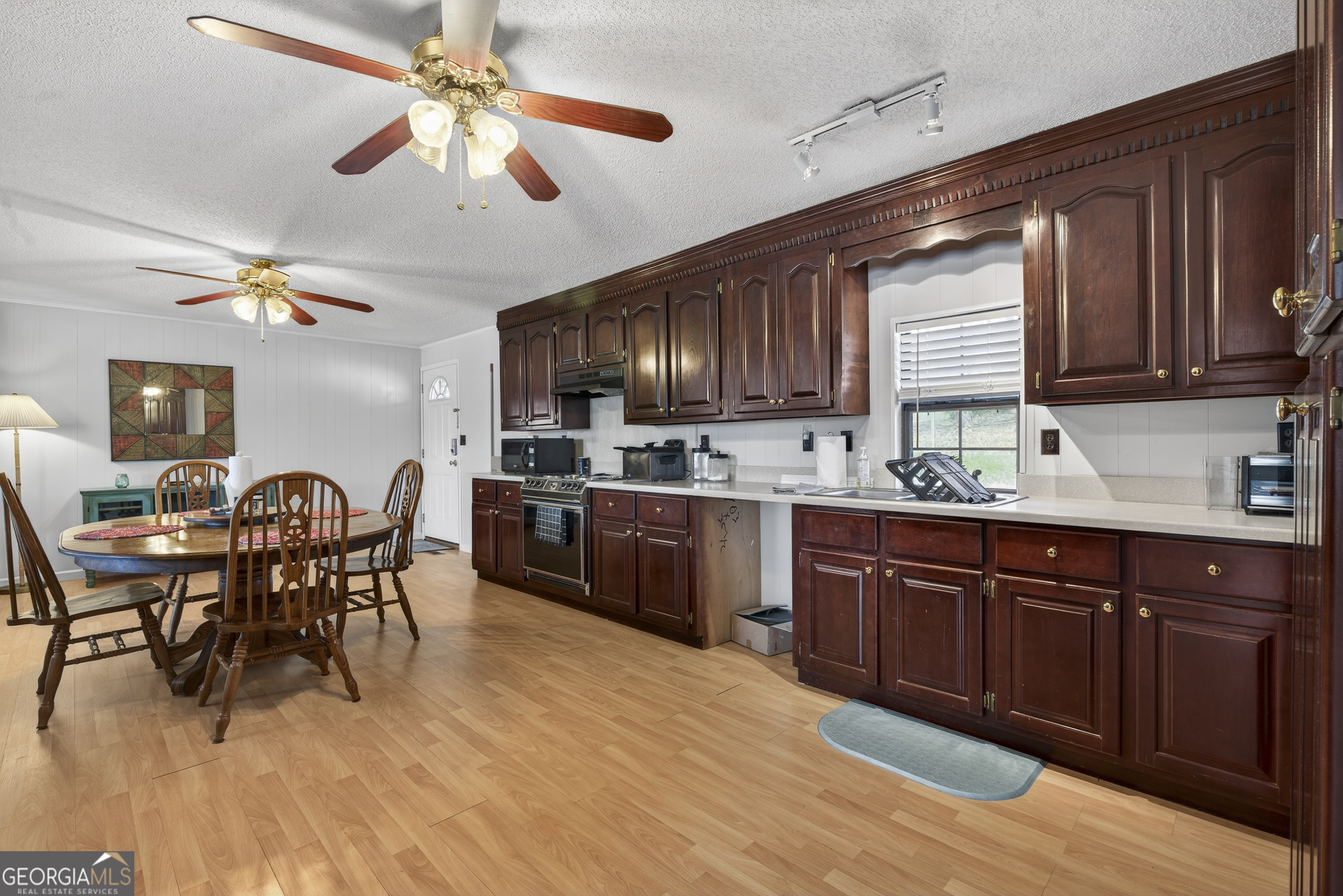 231 B Little Road Northwest Milledgeville, GA 31061 - Photo 18 of 67 a kitchen with stainless steel appliances wooden floors and wooden cabinets