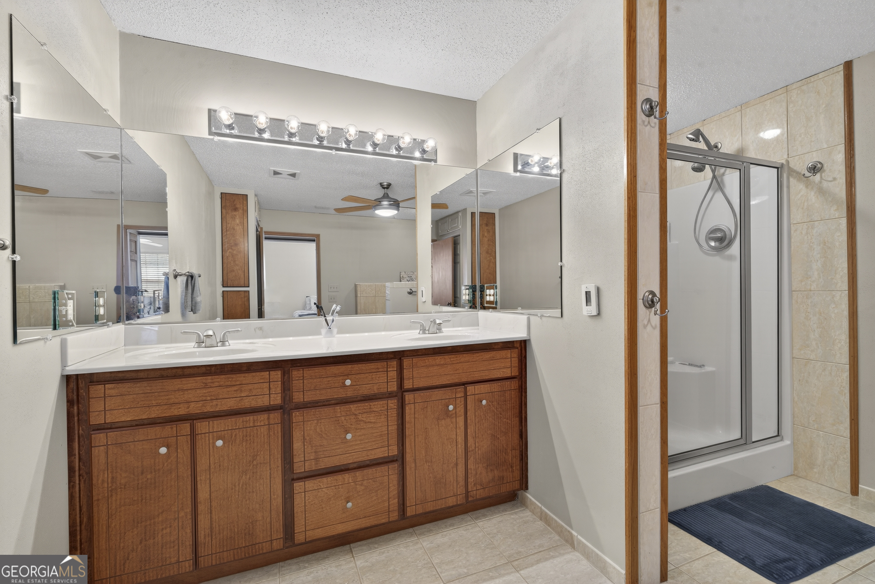 231 B Little Road Northwest Milledgeville, GA 31061 - Photo 37 of 67 a bathroom with a granite countertop sink mirror and a shower