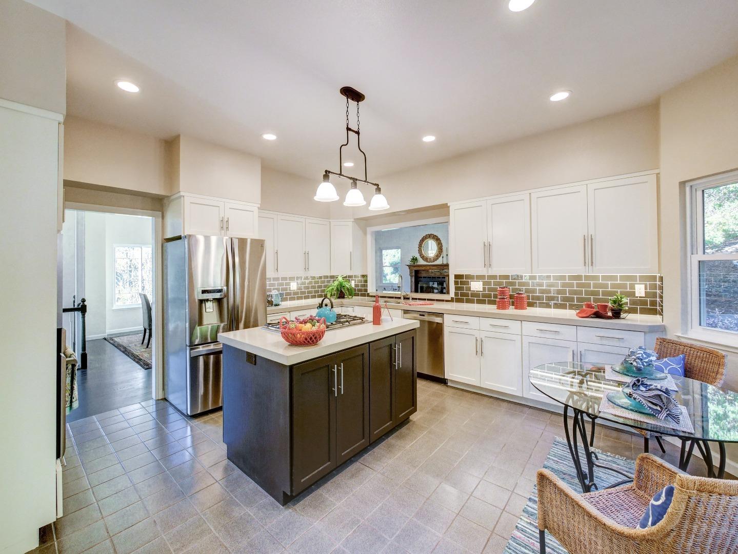 40 Nunes Road Watsonville, CA 95076 - Photo 2 of 42 a kitchen with stainless steel appliances kitchen island granite countertop a table and chairs in it