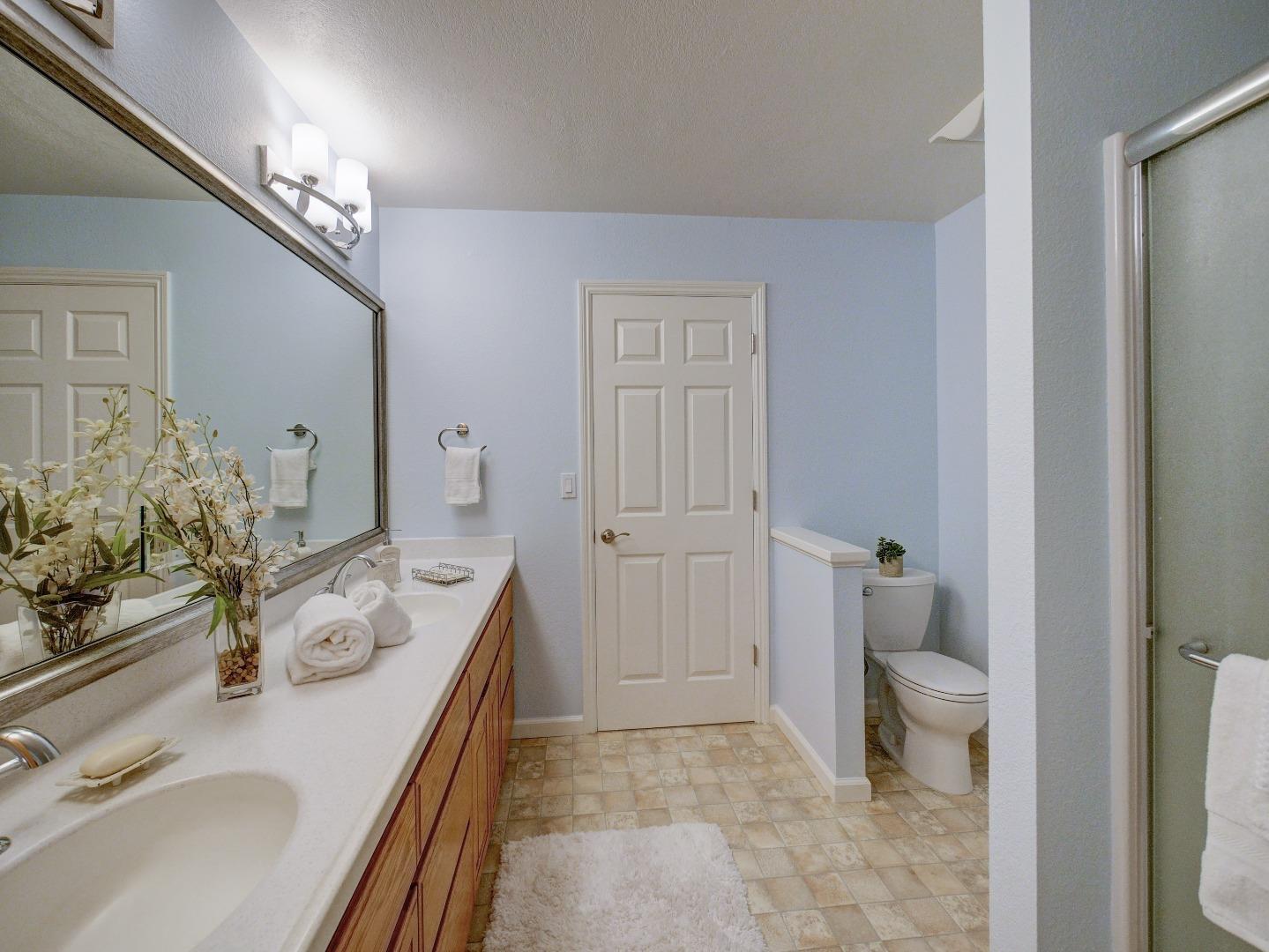 40 Nunes Road Watsonville, CA 95076 - Photo 26 of 42 a spacious bathroom with a granite countertop sink a toilet a large mirror and vanity