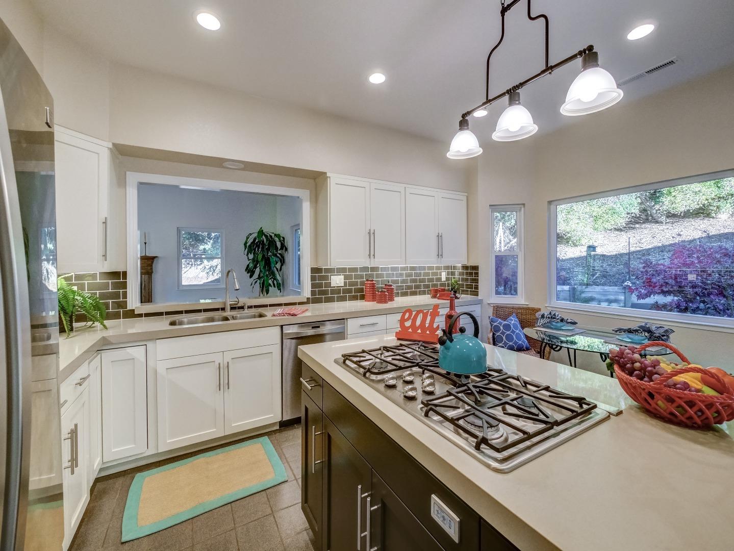 40 Nunes Road Watsonville, CA 95076 - Photo 5 of 42 a kitchen with kitchen island granite countertop stainless steel appliances a stove a sink and a large refrigerator