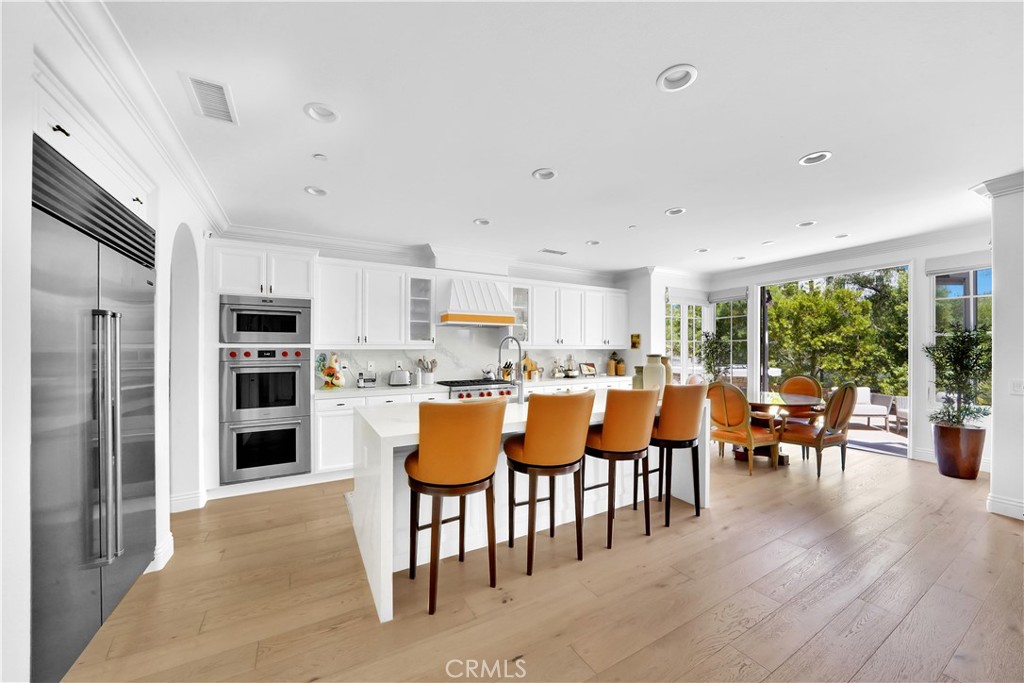 11 Hidden Pass Newport Coast, CA 92657 - Photo 22 of 59 a large kitchen with lots of furniture and stainless steel appliances