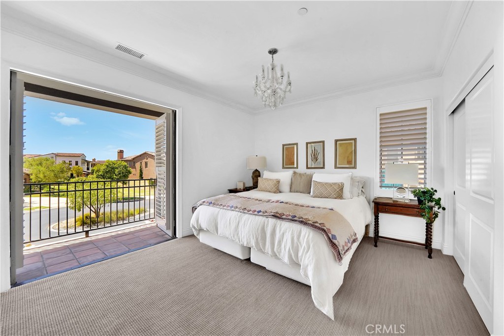 11 Hidden Pass Newport Coast, CA 92657 - Photo 33 of 59 a spacious bedroom with a bed and a chandelier