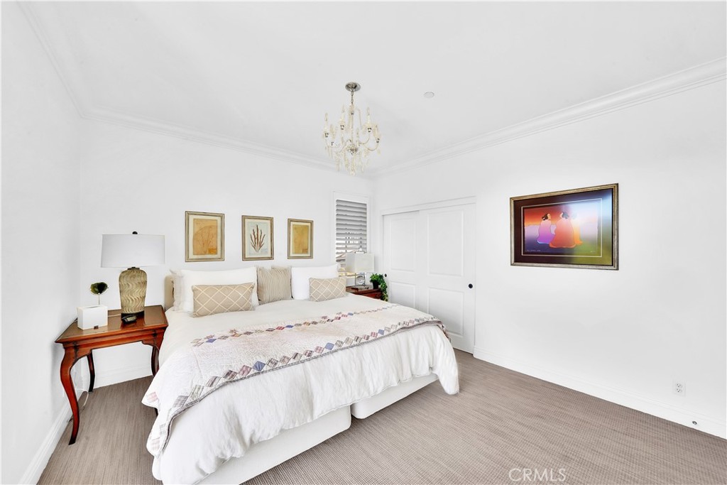 11 Hidden Pass Newport Coast, CA 92657 - Photo 34 of 59 a bedroom with a bed and a chandelier