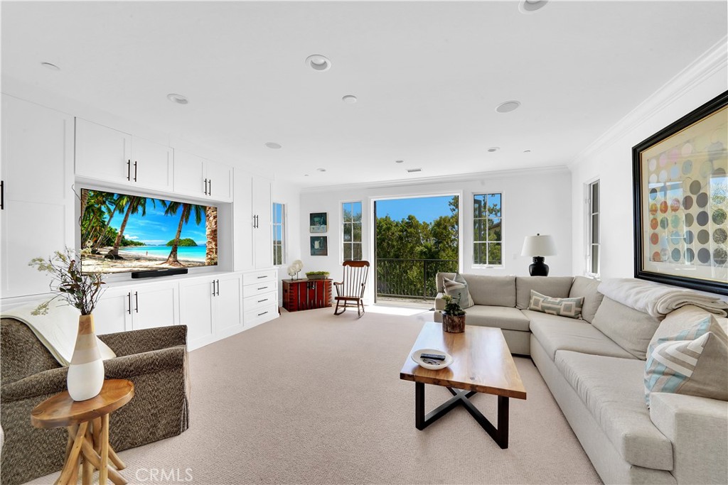 11 Hidden Pass Newport Coast, CA 92657 - Photo 39 of 59 a living room with furniture a flat screen tv and a large window