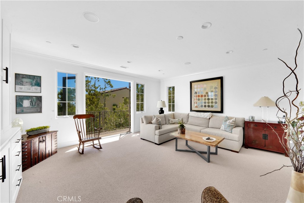 11 Hidden Pass Newport Coast, CA 92657 - Photo 40 of 59 a living room with furniture ceiling fan and a window