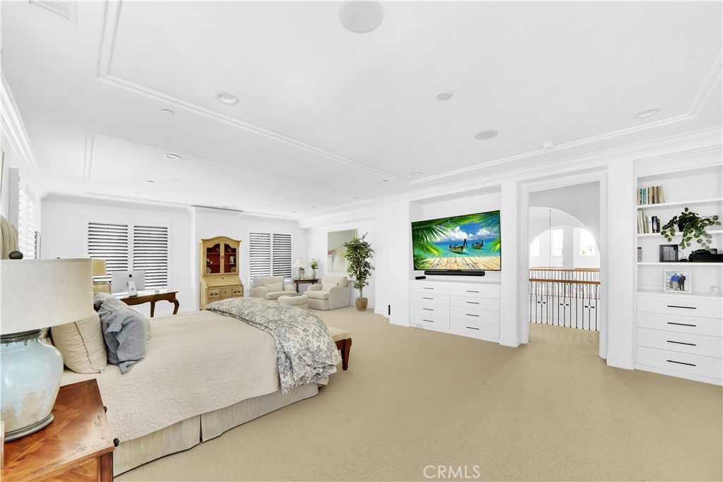 11 Hidden Pass Newport Coast, CA 92657 - Photo 45 of 59 a spacious bedroom with a bed and a flat screen television
