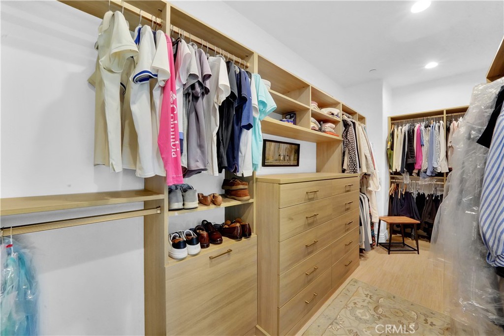 11 Hidden Pass Newport Coast, CA 92657 - Photo 50 of 59 a view of walk in closet with clothes and shoes