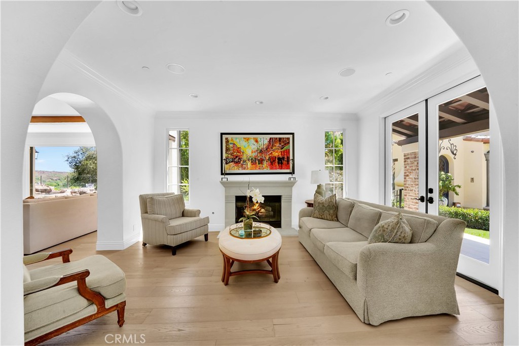 11 Hidden Pass Newport Coast, CA 92657 - Photo 7 of 59 a living room with fireplace furniture and a large window