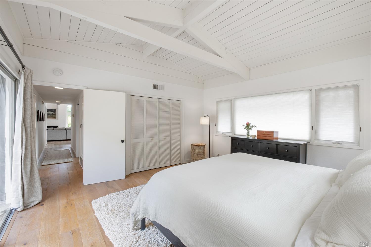 9 Bay Vista Drive Mill Valley, CA 94941 - Photo 21 of 34 a large bedroom with a bed and wooden floor