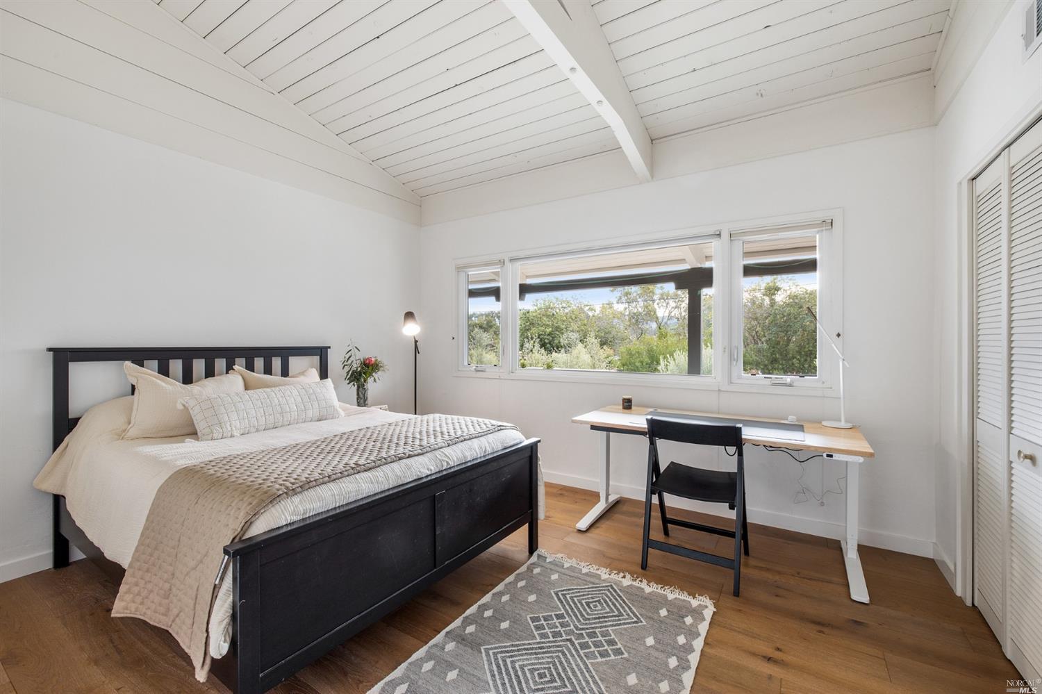 9 Bay Vista Drive Mill Valley, CA 94941 - Photo 24 of 34 a bedroom with a bed a table and a window