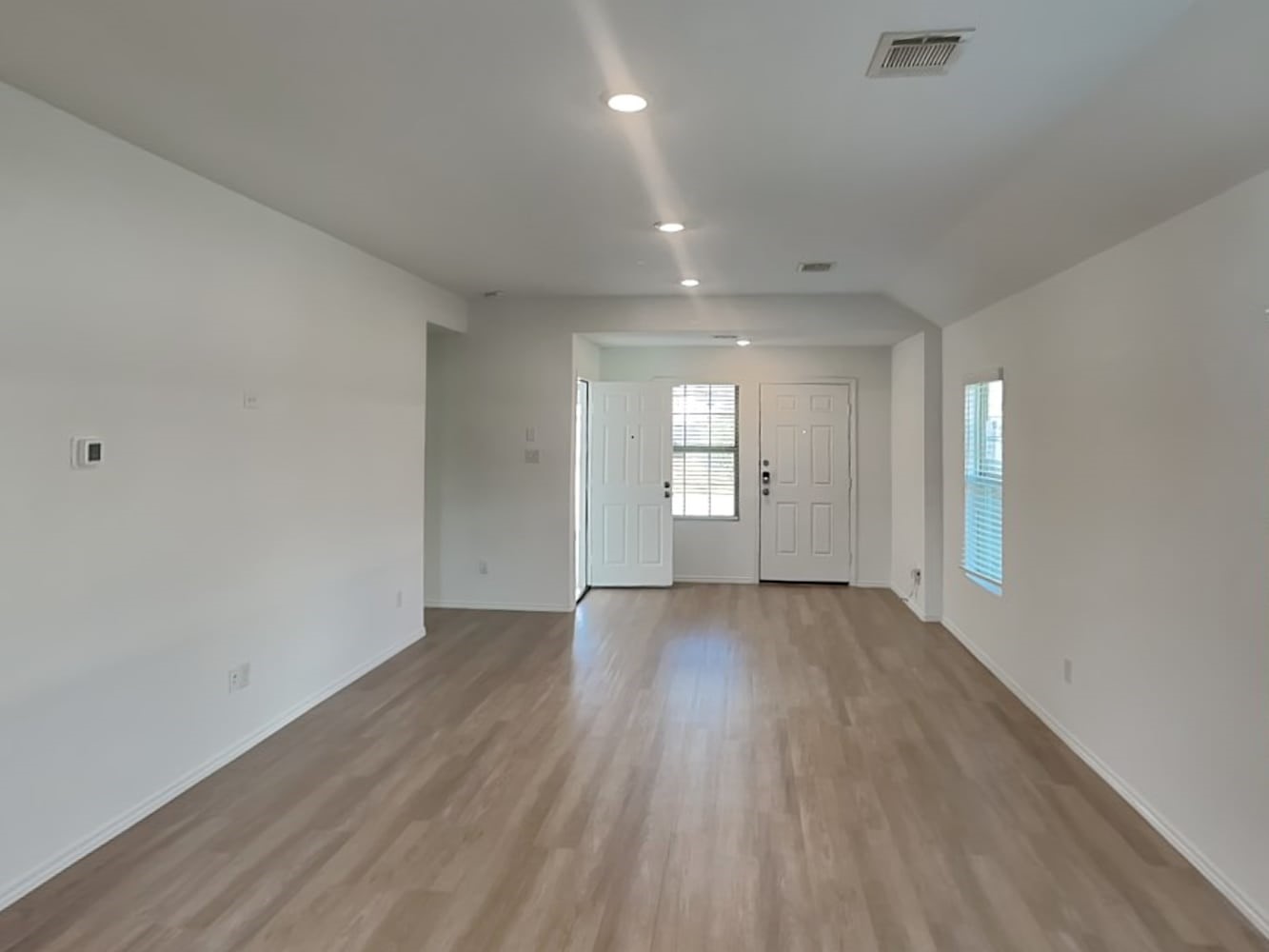 5936 Rimini Landing Lane Porter, TX 77365 - Photo 3 of 15 an empty room with wooden floor and windows