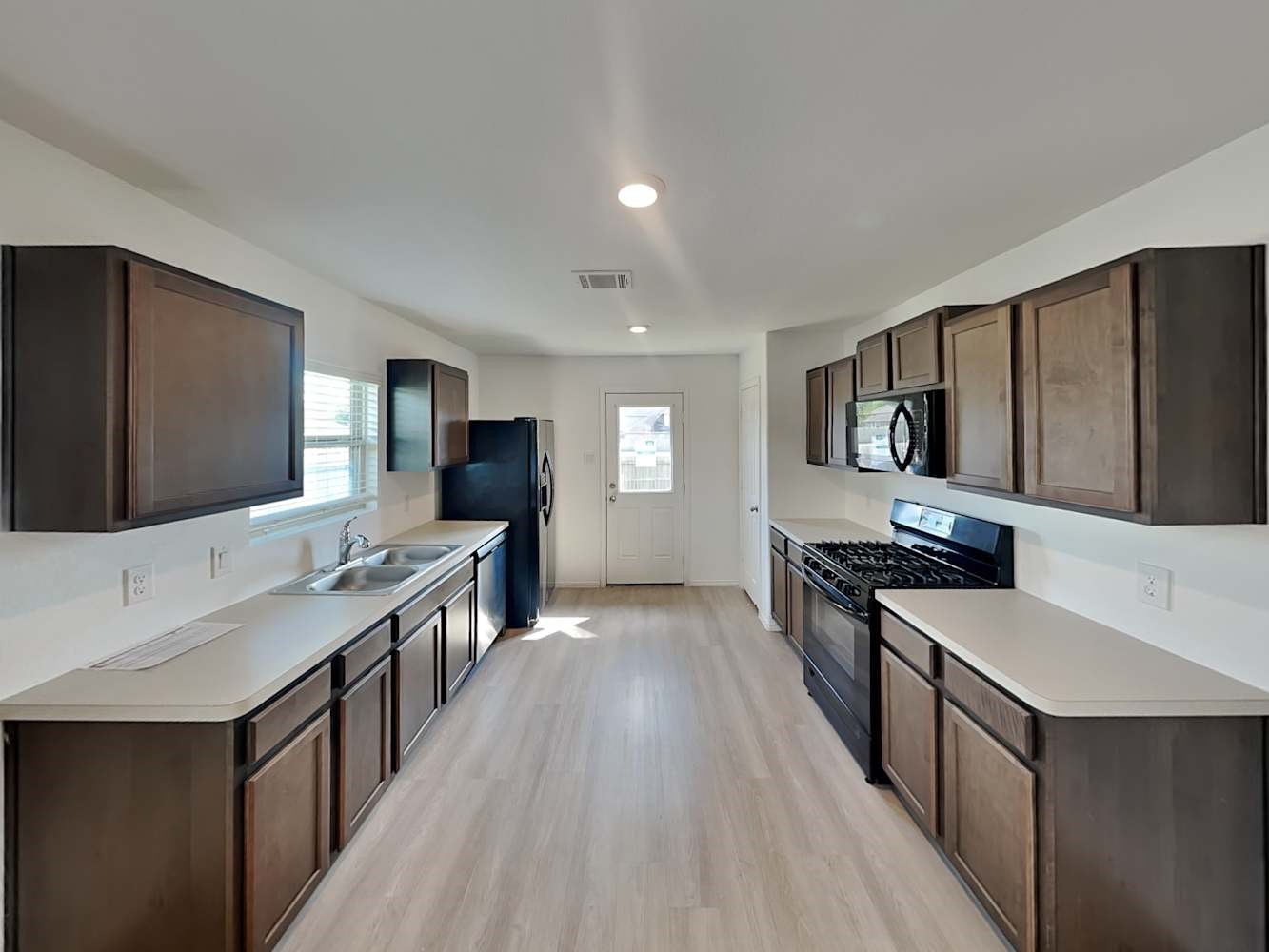 5936 Rimini Landing Lane Porter, TX 77365 - Photo 4 of 15 a kitchen with stainless steel appliances a sink stove and refrigerator