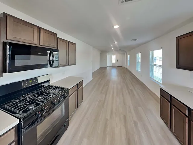 a kitchen with stainless steel appliances granite countertop a stove and a sink