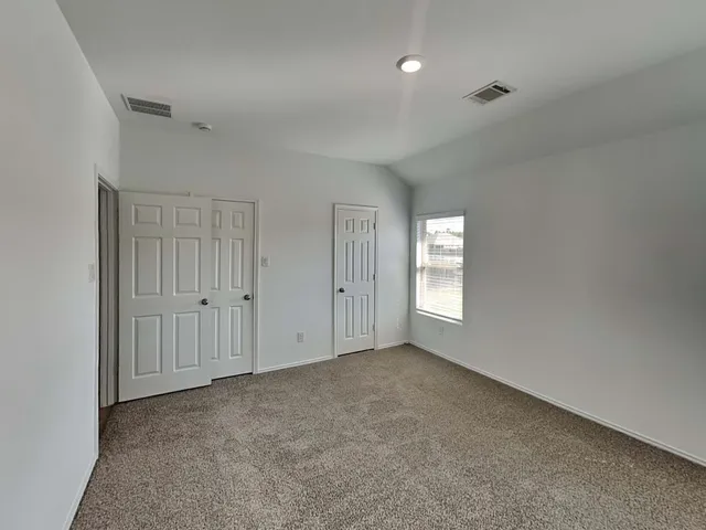 a view of an empty room with windows