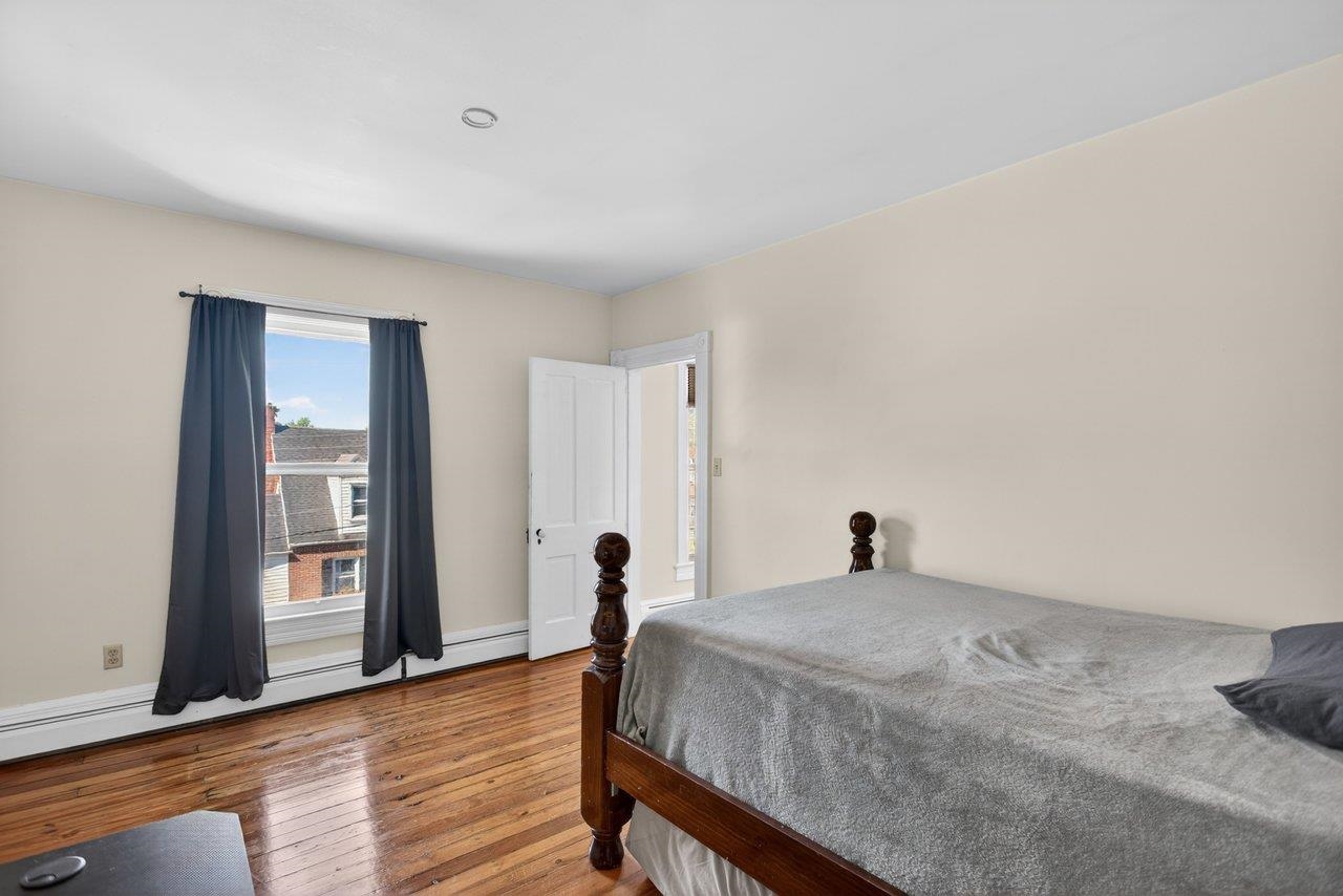 420 West Spring Street Woodstock, VA 22664 - Photo 36 of 67 a bedroom with a bed and wooden floor