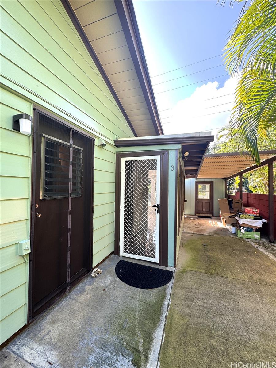 678 Auwina Street, Unit 3 Kailua, HI 96734 - Photo 11 of 11 a view of a house with backyard and porch