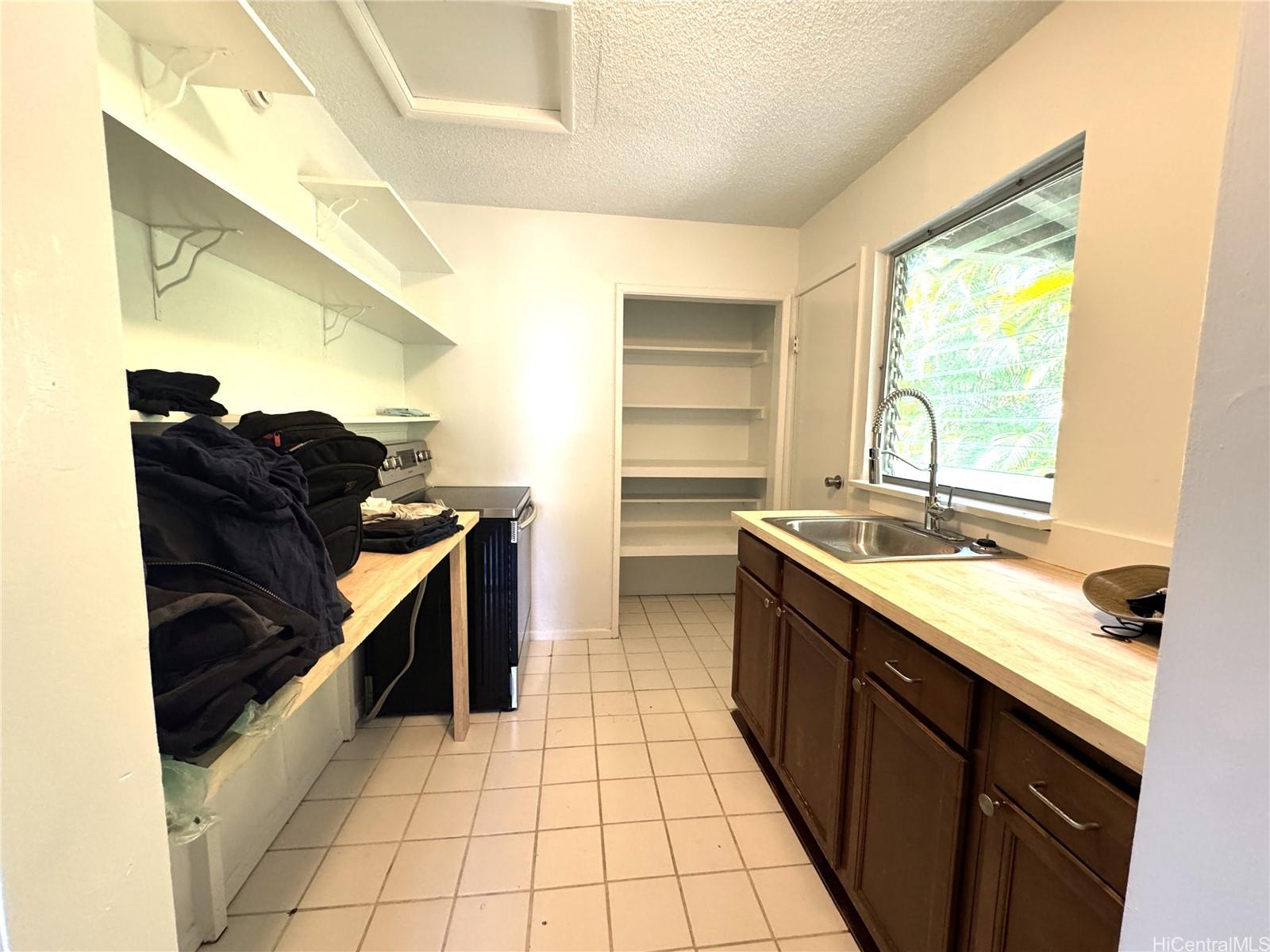 678 Auwina Street, Unit 3 Kailua, HI 96734 - Photo 2 of 11 a kitchen with a sink and a stove top oven