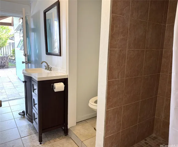 a bathroom with a sink a toilet and mirror
