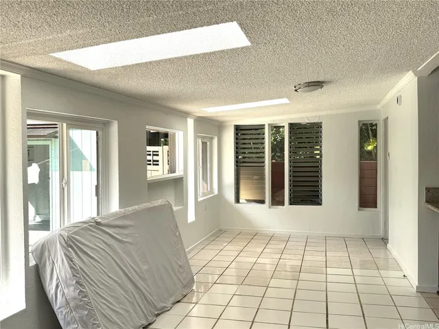 a view of a bedroom with wooden floor and windows