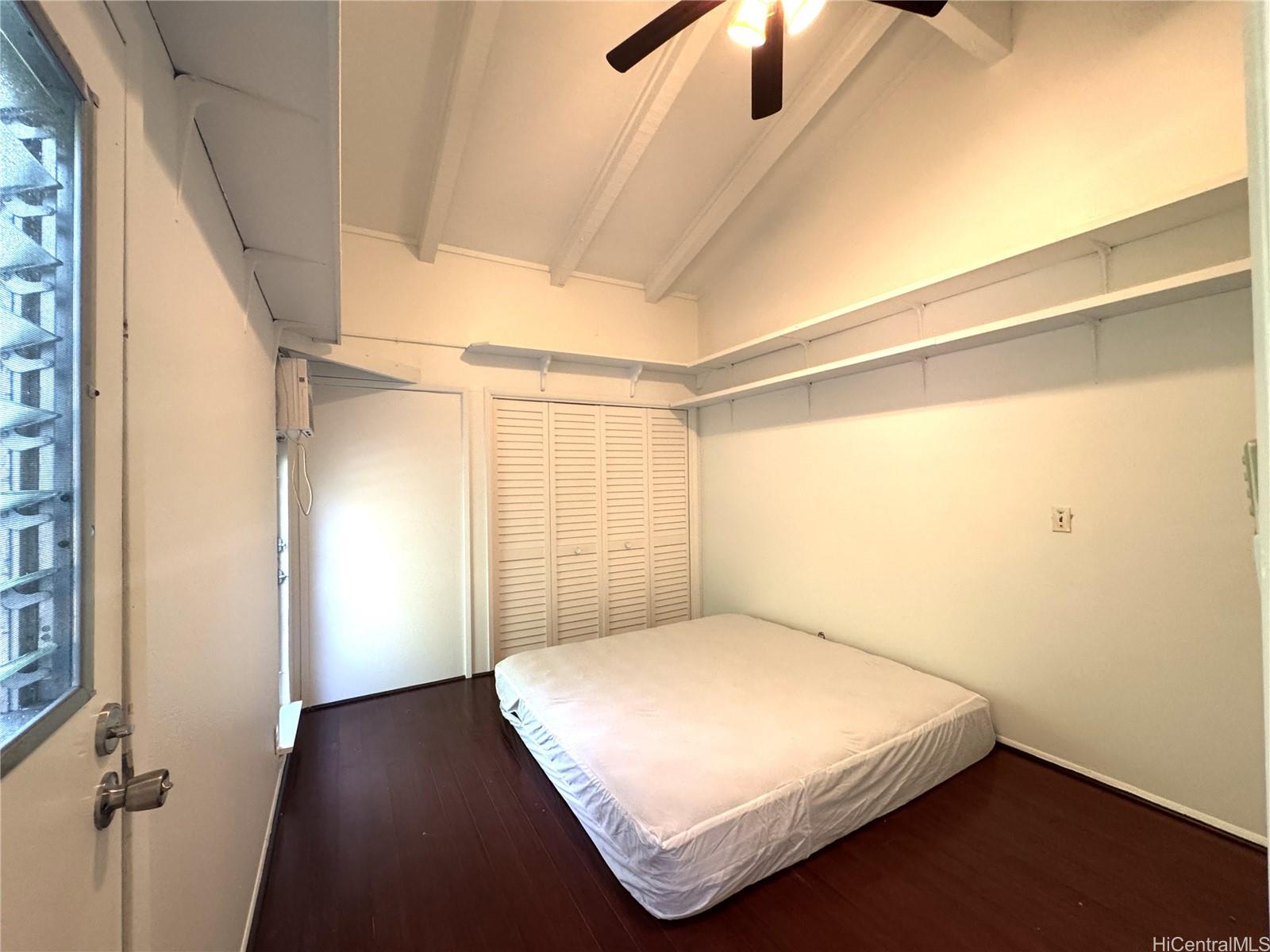 678 Auwina Street, Unit 3 Kailua, HI 96734 - Photo 10 of 11 a bedroom with a bed and a window with the outer view