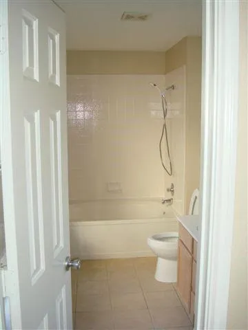 a bathroom with a shower a toilet and a shower