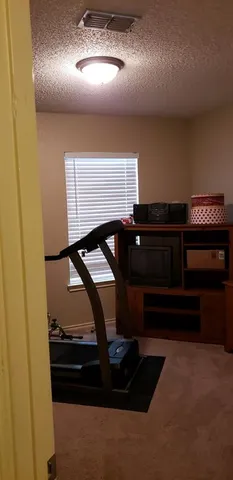 a bedroom with a bed and a bookshelf