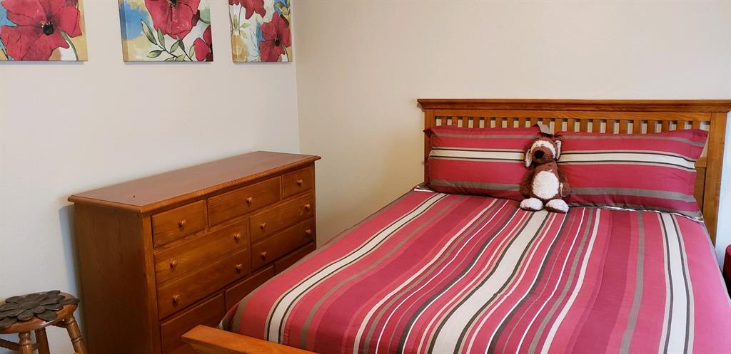 4173 Tupelo Trail Fort Worth, TX 76244 - Photo 8 of 10 a bedroom with a bed and a bookshelf