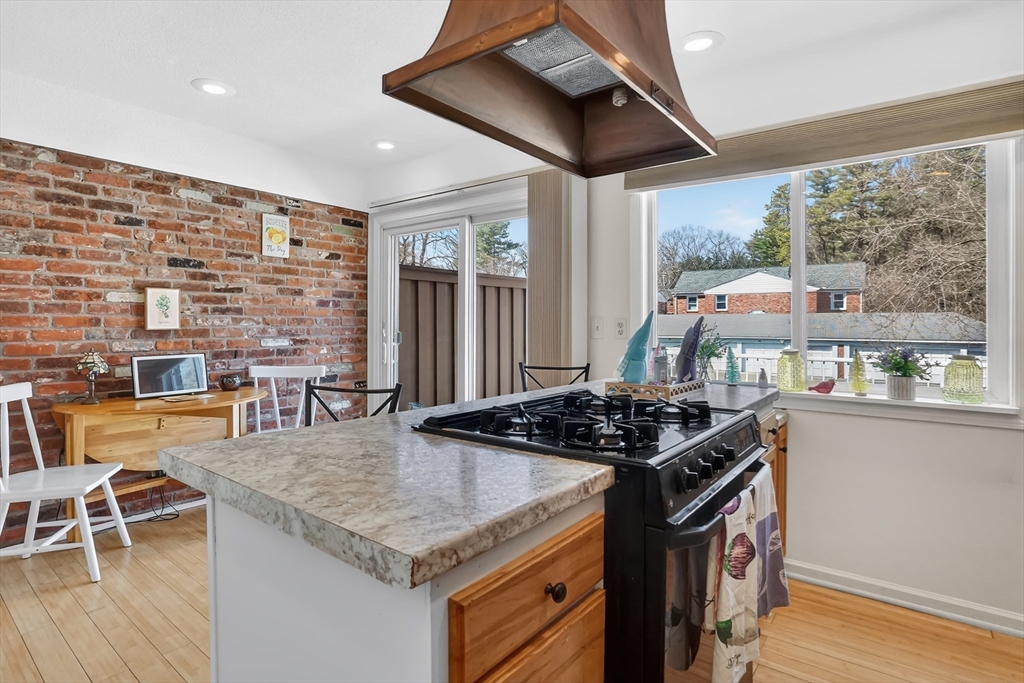 80 Yorktown Drive, Unit 80 Springfield, MA 01108 - Photo 11 of 24 a kitchen with stainless steel appliances granite countertop a stove a refrigerator and a dining table
