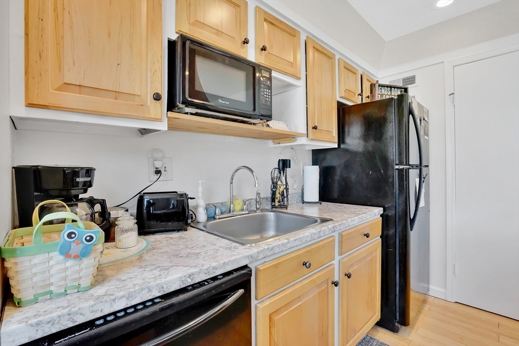 80 Yorktown Drive, Unit 80 Springfield, MA 01108 - Photo 12 of 24 a kitchen with granite countertop stainless steel appliances a sink stove top oven and microwave