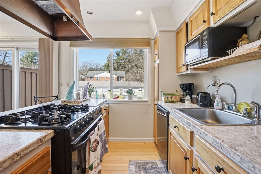 80 Yorktown Drive, Unit 80 Springfield, MA 01108 - Photo 13 of 24 a kitchen with a stove and a sink
