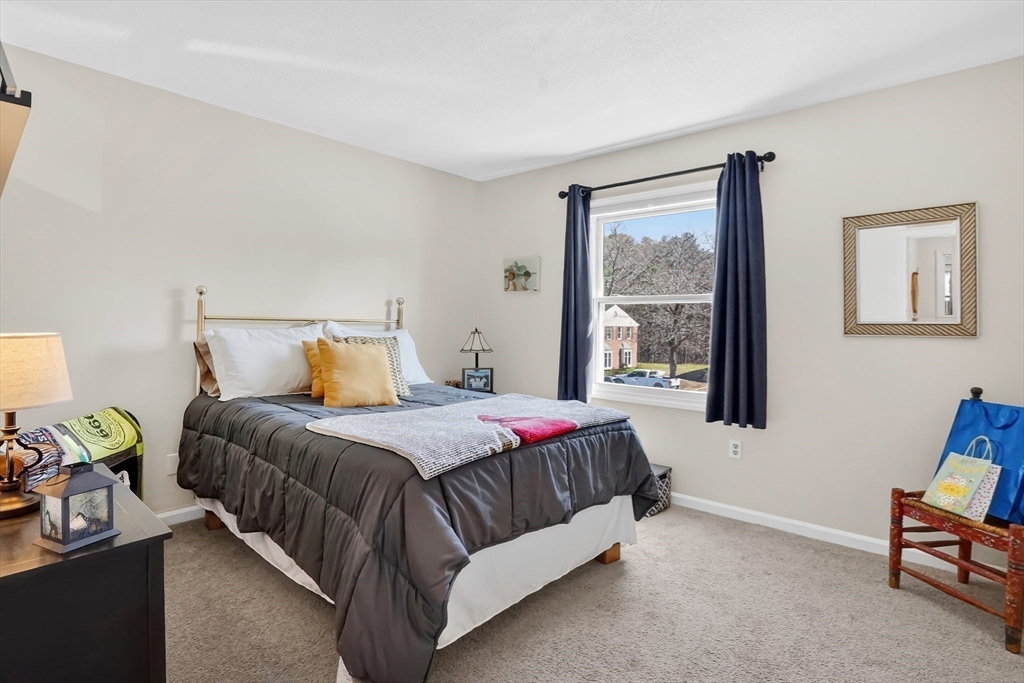 80 Yorktown Drive, Unit 80 Springfield, MA 01108 - Photo 17 of 24 a bedroom with a bed lamp and a window