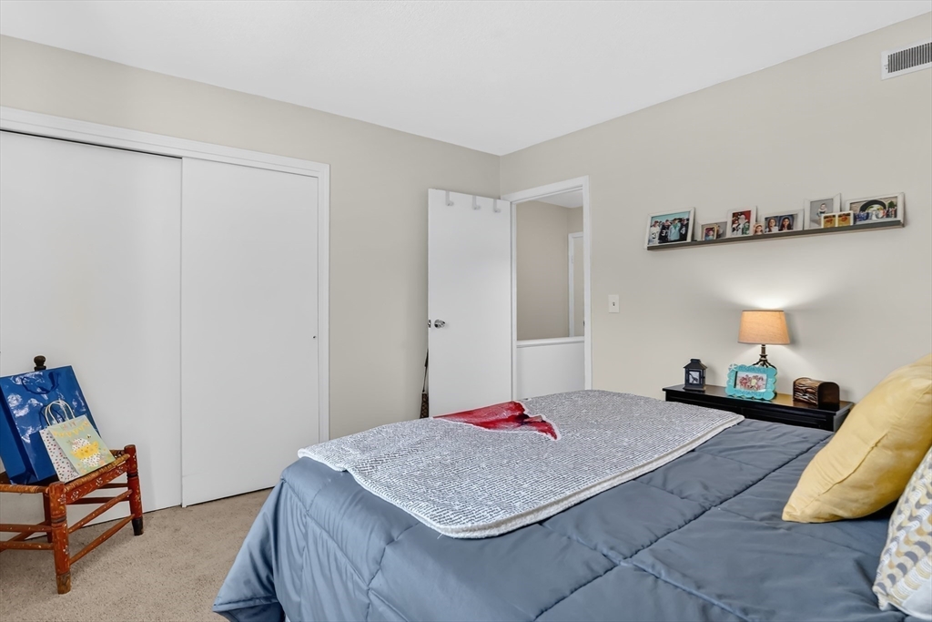 80 Yorktown Drive, Unit 80 Springfield, MA 01108 - Photo 18 of 24 a bedroom with a bed and wooden floor