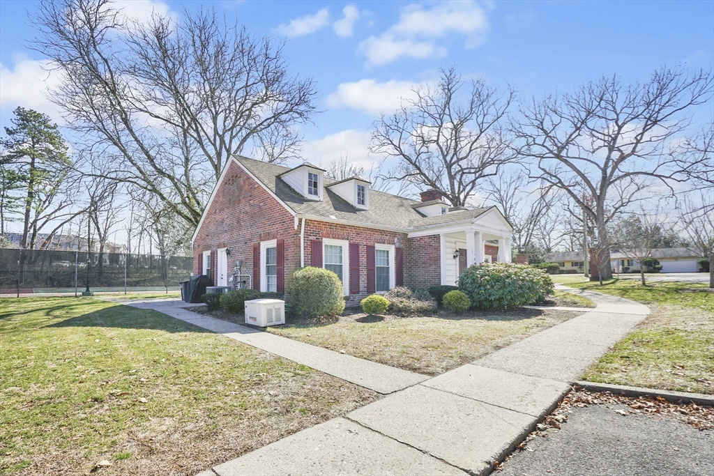80 Yorktown Drive, Unit 80 Springfield, MA 01108 - Photo 21 of 24 a front view of a house with garden and trees