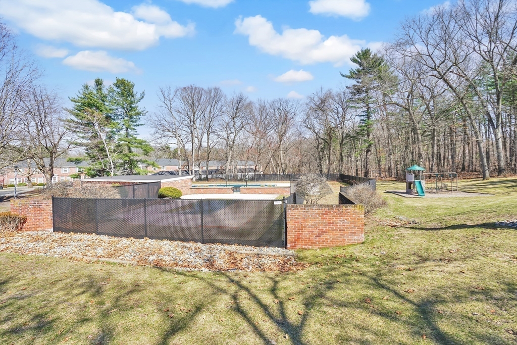 80 Yorktown Drive, Unit 80 Springfield, MA 01108 - Photo 22 of 24 a view of a swimming pool with a bench