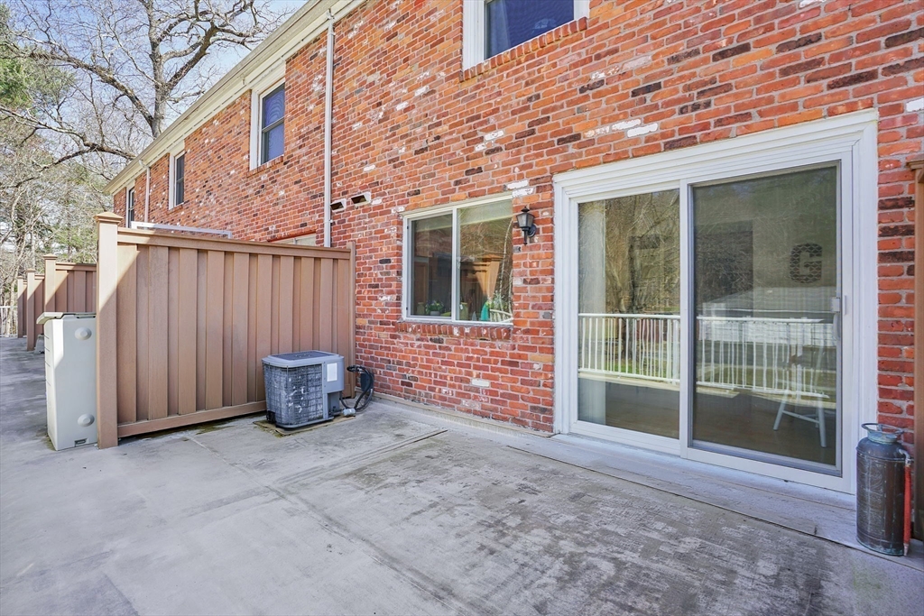 80 Yorktown Drive, Unit 80 Springfield, MA 01108 - Photo 24 of 24 a view of a backyard with door and wooden fence