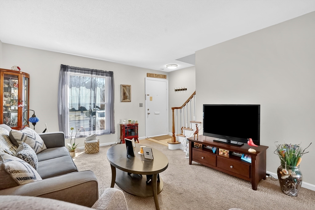 80 Yorktown Drive, Unit 80 Springfield, MA 01108 - Photo 6 of 24 a living room with furniture and a flat screen tv