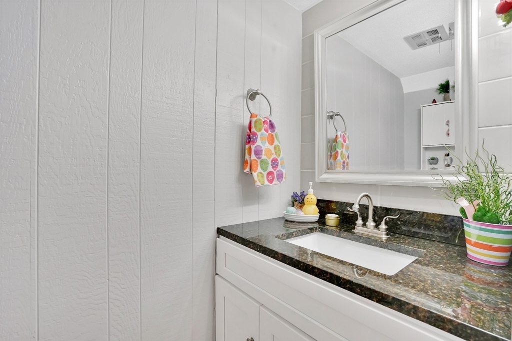 80 Yorktown Drive, Unit 80 Springfield, MA 01108 - Photo 9 of 24 a bathroom with a granite countertop sink and a mirror