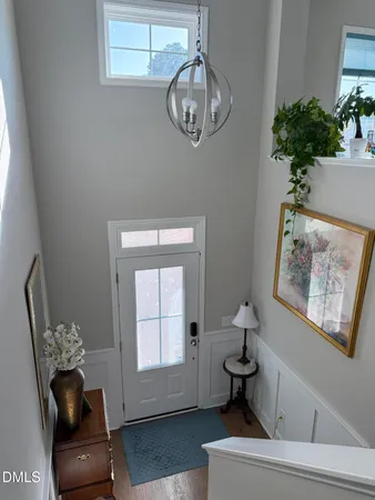 a dining room with stainless steel appliances a dining table chairs refrigerator and sink