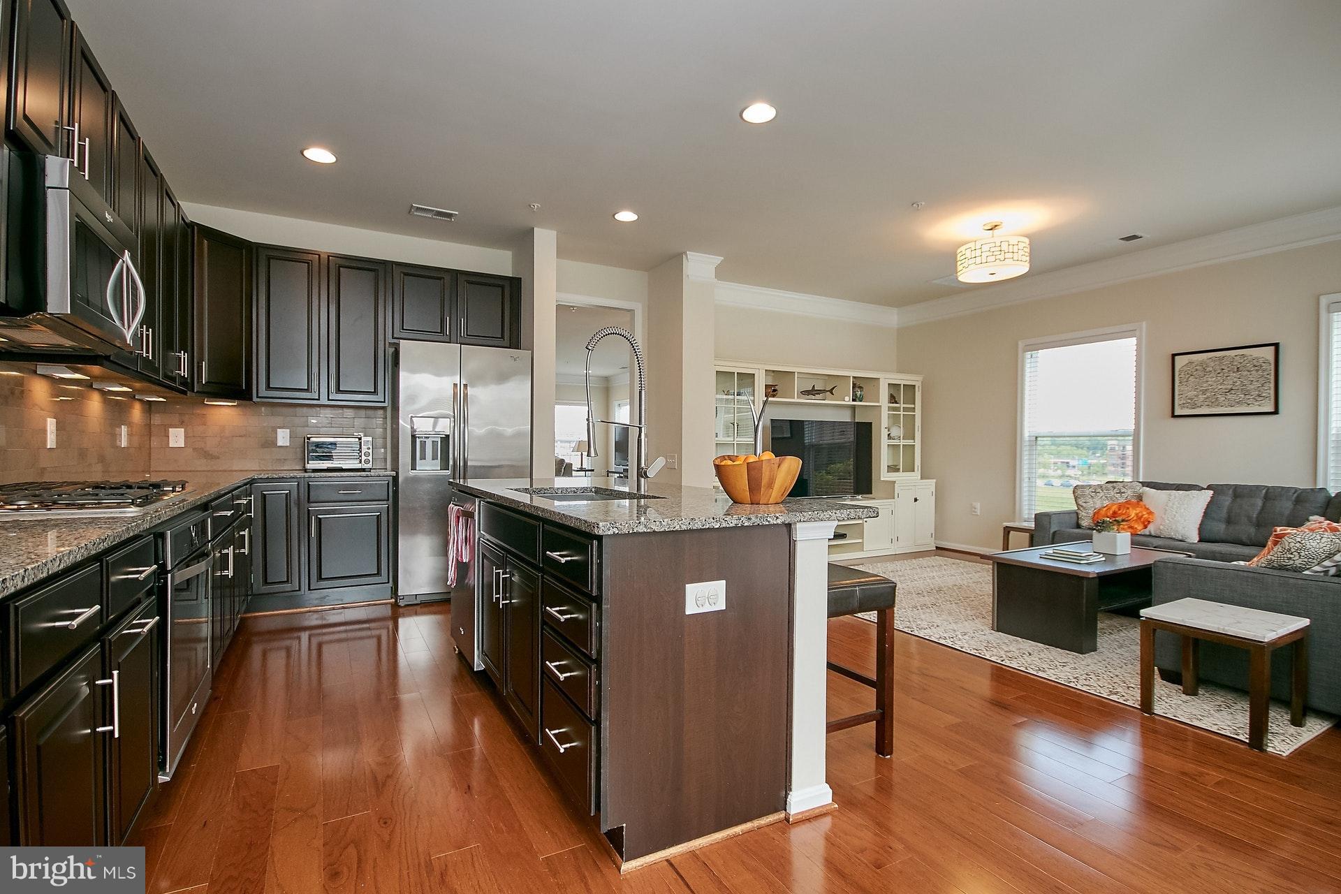 3073 Rittenhouse Circle, Unit 60 Fairfax, VA 22031 - Photo 11 of 30 a kitchen with stainless steel appliances granite countertop wooden cabinets a sink a stove a refrigerator and dishwasher a oven with wooden floor