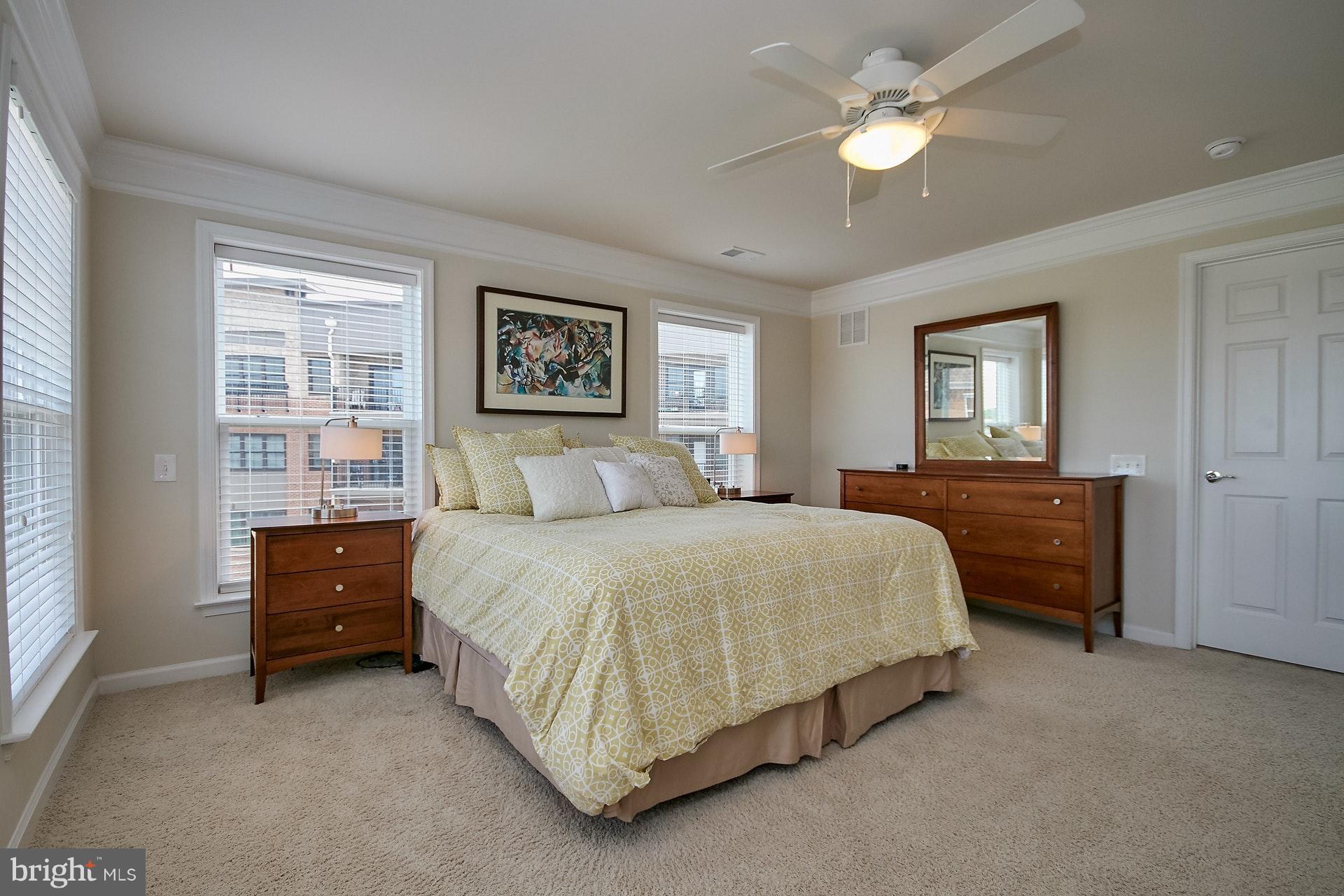 3073 Rittenhouse Circle, Unit 60 Fairfax, VA 22031 - Photo 20 of 30 a bedroom with a bed and a chandelier