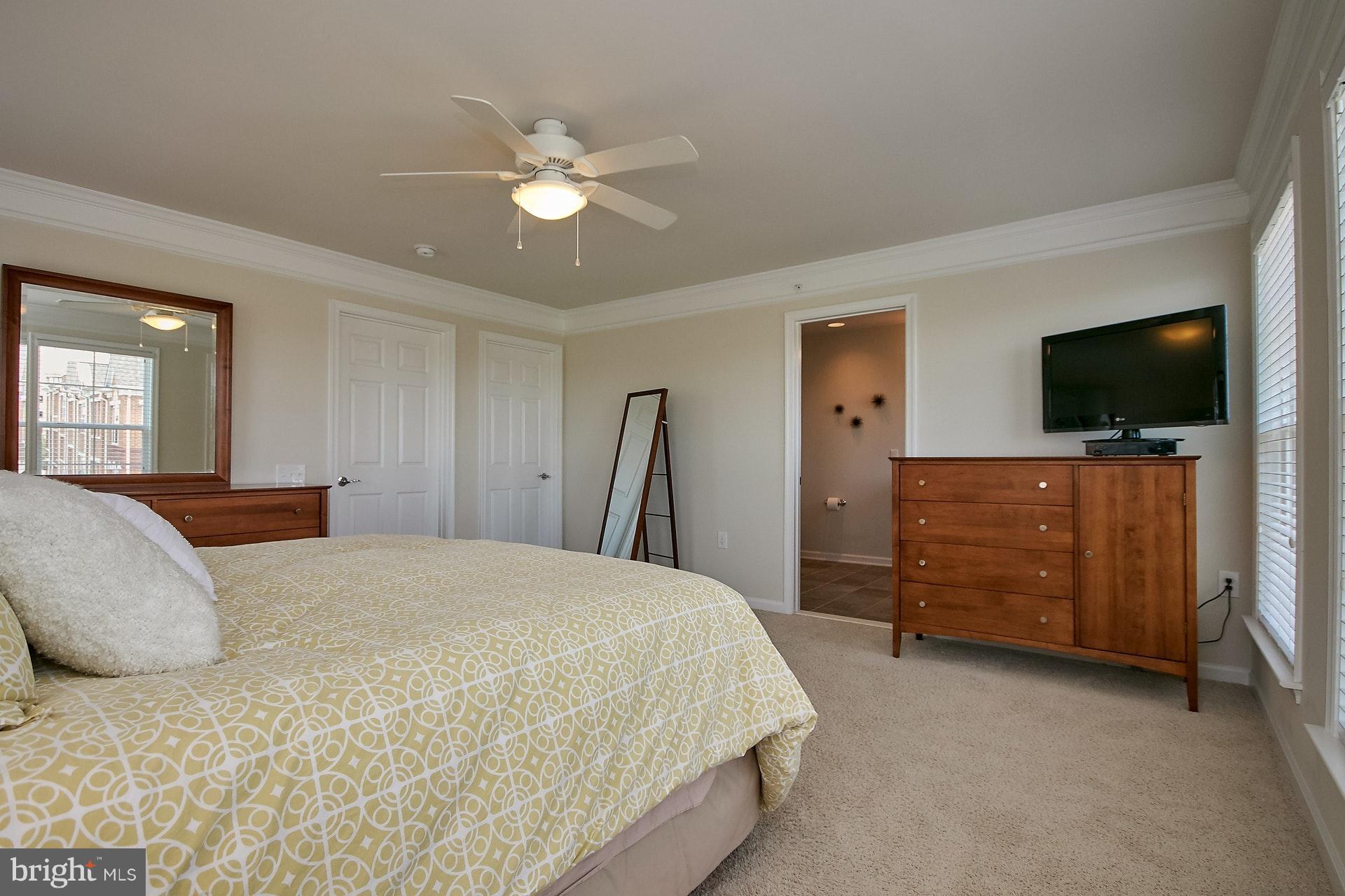3073 Rittenhouse Circle, Unit 60 Fairfax, VA 22031 - Photo 21 of 30 a spacious bedroom with a bed and a flat screen tv