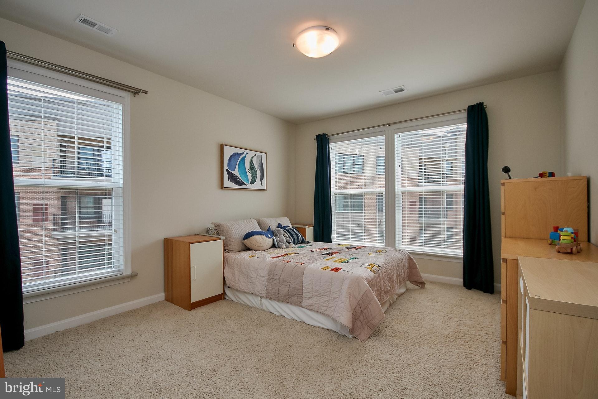 3073 Rittenhouse Circle, Unit 60 Fairfax, VA 22031 - Photo 25 of 30 a bed sitting in a bedroom next to a window